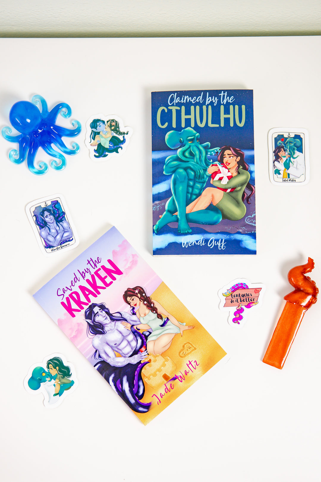 Covers of Saved by a Kraken and Claimed by a Cthulhu surrounded by SteamyBookworms monster romance book box stickers.